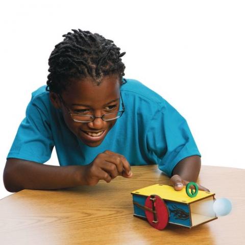 boy firing a ping pong ball out of a box