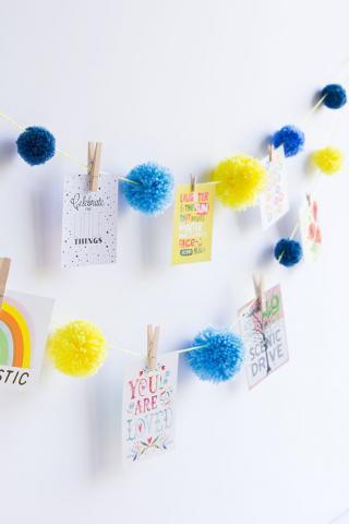 Photos strungs on pom pom garland