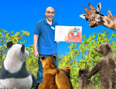 Mr Jose holding a book with animals