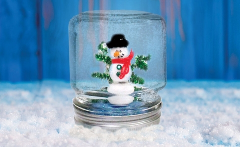 Snowman in a mason jar with glitter.